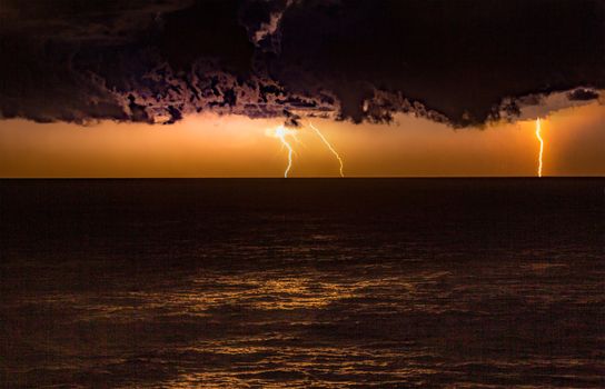 Storm over the ocean with lightning bolts