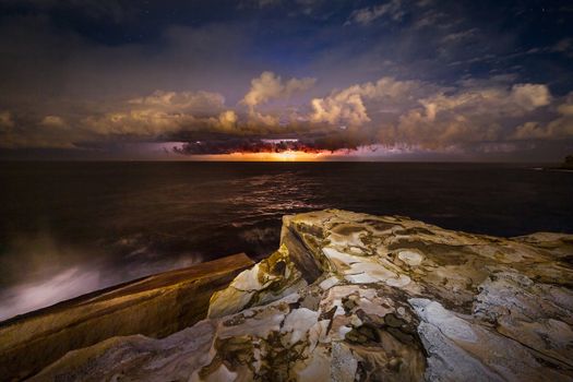 Brilliant lightning storm that formed just off the coast of Sydney lights up the entire sky and clouds.  Single shot capturing 5 lightning bolts