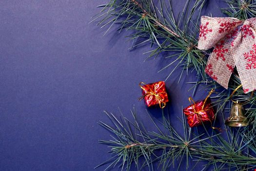 coniferous branches and Christmas tree decorations on a New Year's dark background, copy space.