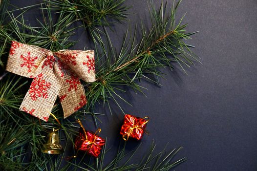 coniferous branches and Christmas tree decorations on a New Year's dark background, copy space.