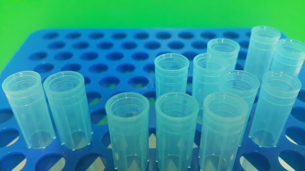 Close up view of blue micro litre tips in microtip box with empty holes. Reseach lab. tool for accurate measurement.
