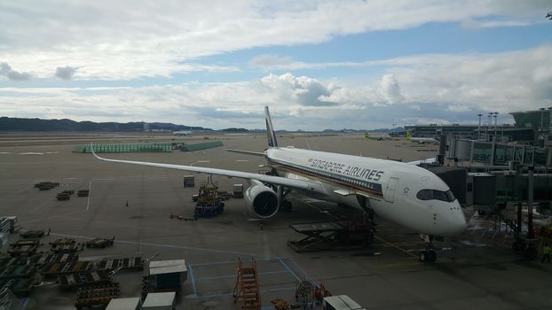 Beijing Airport, china- April 2019: Passenger plane standing in airport on the concrete paved runway terminal for loading, boarding and maintenance before take off for predestined flights.