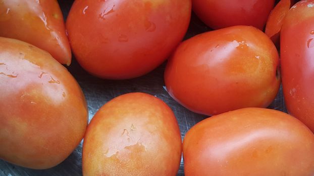 Red tomatoes in super market for sale. A background for text and advertisements