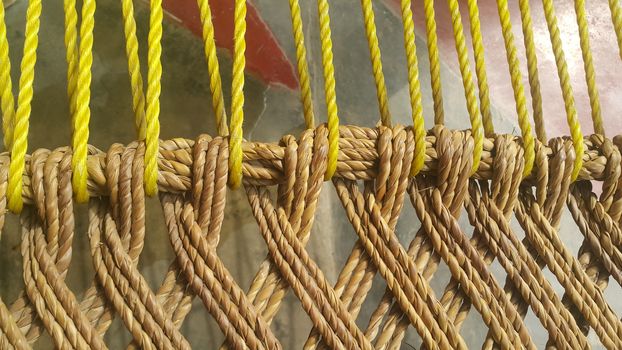 Closeup view of dried jute thread or ropes interwoven for making traditional old style bed called charpai