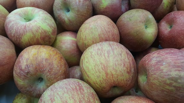 Fresh picked red honey crispy apples background in the harvest season placed in a market or bazaar for sale