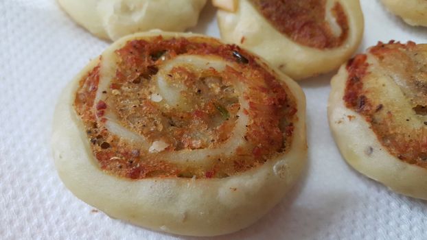 Closeup of delicious home made pinwheel puff pastries food item placed over white background