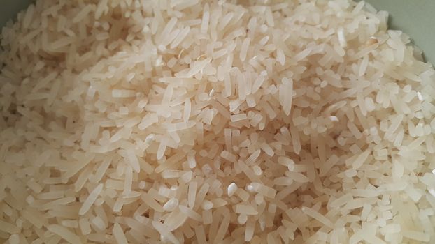 Top closeup view of heap of rice. Rice is the most consumed food ingredient in the world