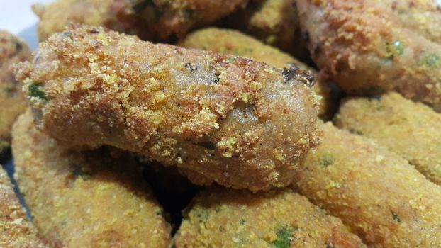 Closeup perspective view of home made spicy and delicious croquettes served with tea or other dishes during parties as fast food.