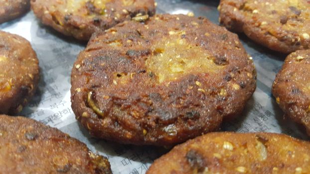 Closeup perspective view with selective focus of delicious spicy fried kebab, kebab or chapli kebab. Asian recipe. Asian spicy cuisine.