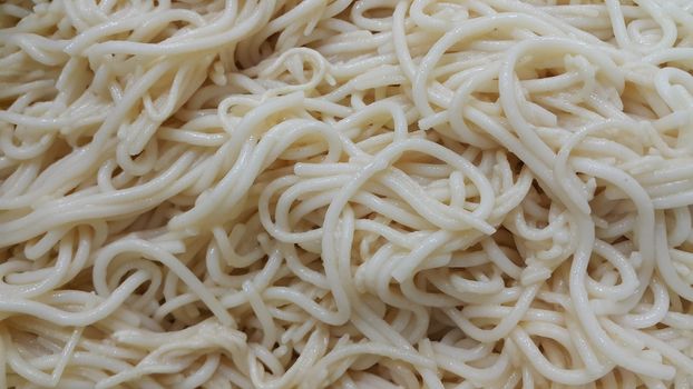 close up view of swirling noodles or spaghetti pasta for eating. Food background for fast foods