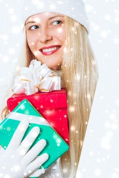 Magical Christmas and glitter snow background, happy blonde with gift boxes in winter season for shopping sale and holiday brands