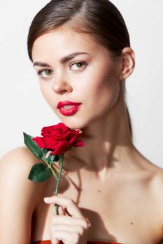 Woman with rose Bare shoulders red lips bright makeup cropped view