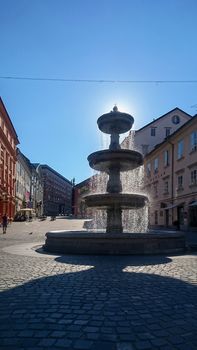 Ljubljana, Slovenia, July 2017: View on Vodnjak na Novem trgu fountain in Ljubljana, Slovenia, looking into Novi trg street