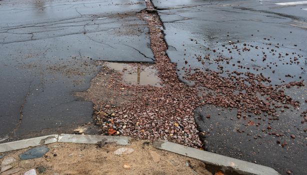 Asphalt road cracked and broken from earthquake