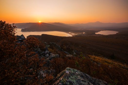 View from above. A beautiful sunset in the Sikhote-Alin Biosphere Reserve in the Primorsky Territory. Golden autumn in the wild