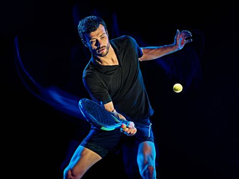 one caucasian Paddle tennis player man studio shot isolated on black background with light painting blur effect