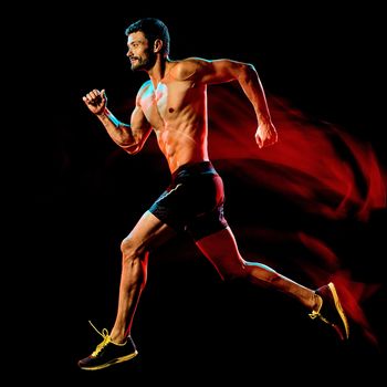 one caucasian topless muscular mature man runner. running jogger jogging isolated on black background with light painting speed mouvement effect