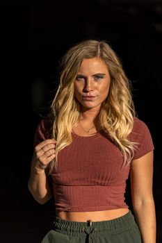 A gorgeous blonde model poses in a parking deck on an autumn day