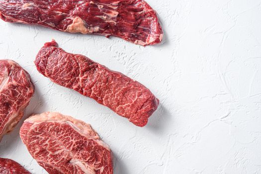 Raw organic machete steak near denver and top blade marble beef on white background top view space for text.