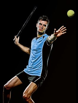 one caucasian young player tennis man in studio isolated on black background