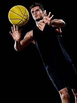 one caucasian young basketball player man in studio isolated on black background