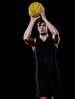 one caucasian young basketball player man in studio isolated on black background