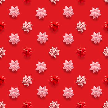 Seamless regular creative Christmas pattern with New Year decorations on red background. xmas Modern Seamless pattern made from christmas decorations. Photo quality pattern for fabric, prints, wallpapers, banners or creative design works.