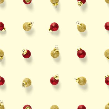 Seamless pattern with red andgold Christmas decorations on yellow background. Christmas red ornaments Seamless pattern. Christmas abstract background made from balls.