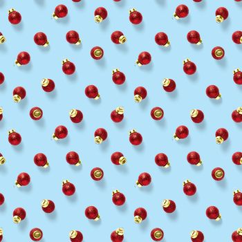 Seamless pattern with red Christmas decorations on blue background. Christmas red ornaments Seamless pattern. Christmas abstract background made from balls.