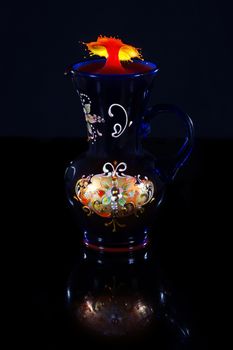 Water drop umbrella shape in an ornate vase. Liquid drop art, water drop photography
