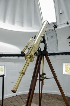 Historic brass telescope set up in the cupola at the top of The King's Observatory in Old Deer Park, Richmond Upon Thames.  The observatory was built in West London for King George III to watch the Transit of Venus in 1769.  