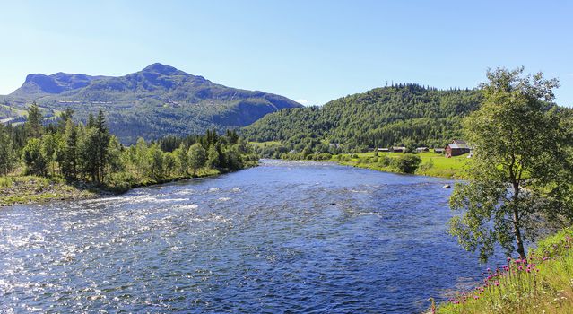 Flowing beautiful river lake Hemsila with mountain panorama in Hemsedal, Viken, Buskerud, Norway.