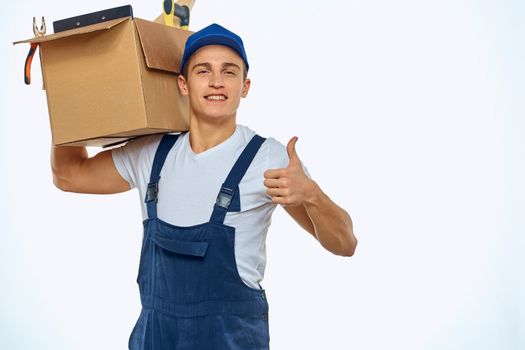 A man in a working uniform with a box in his hand loading a delivery service. High quality photo