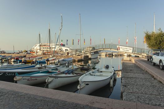 BARDOLINO, ITALY 16 SEPTEMBER 2020: Port on Garda Lake of Bardolino with colored boats