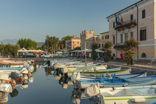 BARDOLINO, ITALY 16 SEPTEMBER 2020: Port on Garda Lake of Bardolino with colored boats