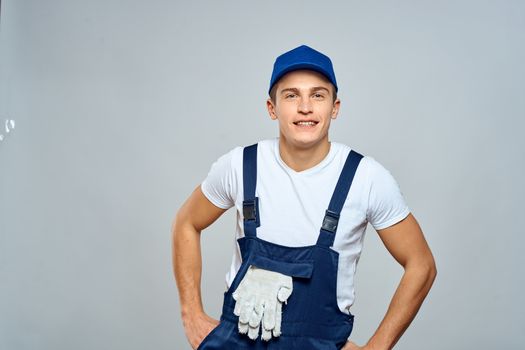 working man in uniform service lifestyle delivery service light background. High quality photo