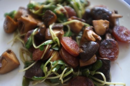 Close up view , Fried Sunflower Sprout and chinese sausage with Oyster Sauce - healthy food style