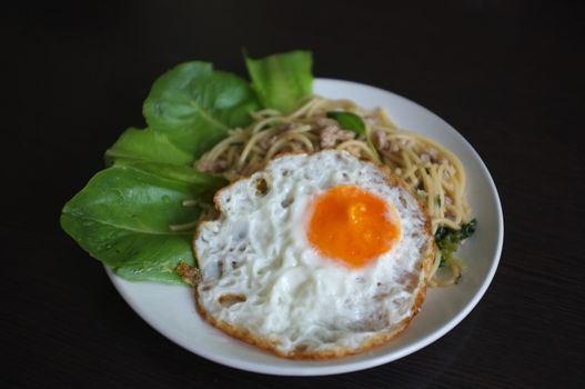 Spaghetti stir fried with Thai Basil spicy sauce with Fried egg  , fusion Thai style