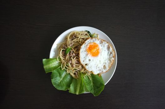 Spaghetti stir fried with Thai Basil spicy sauce with Fried egg  , fusion Thai style