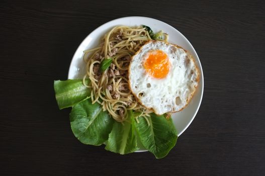 Spaghetti stir fried with Thai Basil spicy sauce with Fried egg  , fusion Thai style