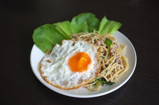 Spaghetti stir fried with Thai Basil spicy sauce with Fried egg  , fusion Thai style