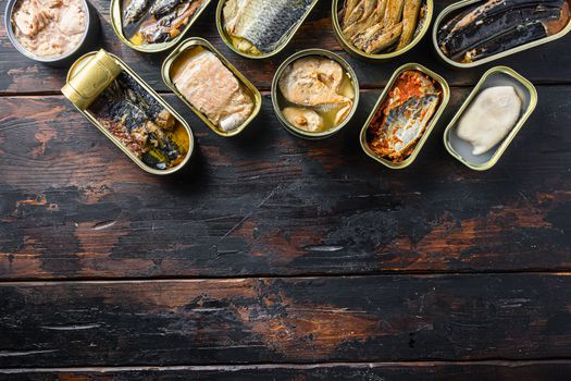 opened cans conserve with Saury, mackerel, sprats, sardines, pilchard, squid, tuna over wood table top view space for text.