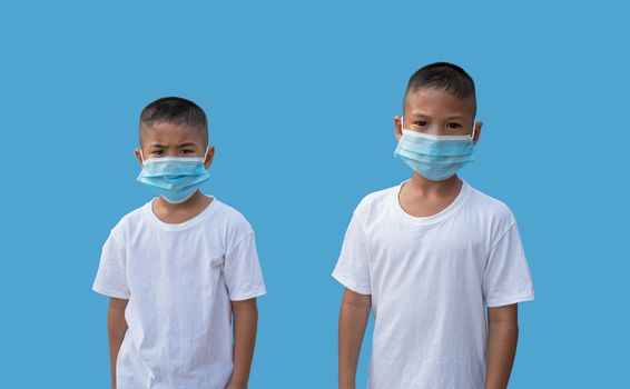 Two boy wearing a protective mask on a blue background. New normal concept.