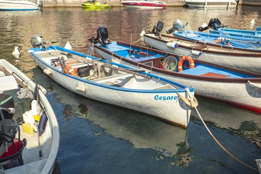 LAZISE, ITALY 16 SEPTEMBER 2020: Dogana Veneta and Porticciolo in Lazise, in Italy with colored boats