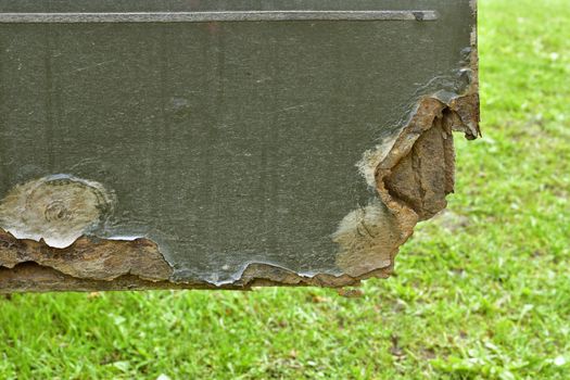 very badly rust-damaged car door, the  door is open