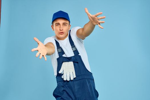 Working man in uniform of gloves loader rendering service blue background. High quality photo