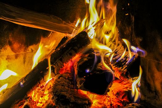 Romantic bright open fire on wood in a hut in Norway.