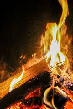 Romantic bright open fire on wood in a hut in Norway.