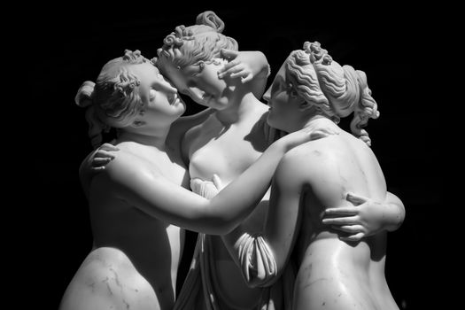 Milan, Italy - June 2020: Antonio Canova’s statue The Three Graces (Le tre Grazie). Neoclassical sculpture, in marble, of the mythological three charites (made in Rome, 1814-1817)