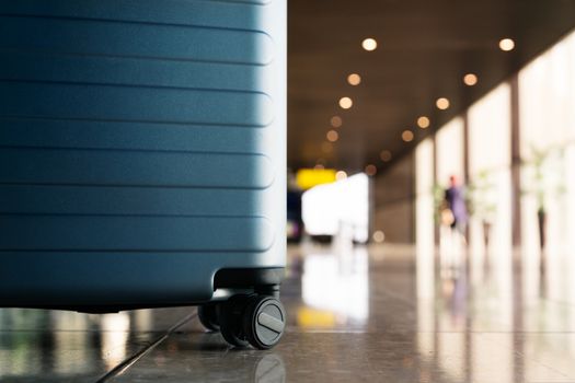 Suitcase in airport departure airport terminal waiting area, ready for vacation, focus on suitcase